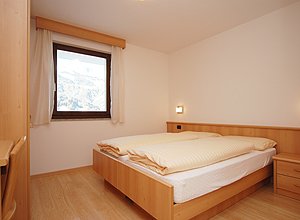 Apartment in Soraga di Fassa. The bed-rooms with one double bed and two single beds.