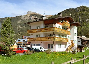 Apartment in Canazei. Exterior Home Cesa Planch on cable car , on the back you can see the cable cars.