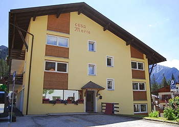 Apartment in Canazei. Welcome to the apartments Cesa Maria	

In the center of Canazei, “Cesa Maria” offers a wide range of comfortable apartments which combine the  typical mountain style furnishings into the warmest welcome.
Walking few steps from Cesa Maria you can reach easily all shops and services of primary importance.
Cesa Maria apartments are about 600 metres from the cable car station in Canazei far away and 2 minutes walking distance from the stop bus, from where you can catch the free ski bus to reach the ski lifts of Canazei, Campitello, or Alba. 
In just two minutes, you'll get to the town park and to the start point of numerous trails for walking.
We offer a large car park with private parking ( two-room apartment: 1 assigned parking space, three-room apartment: 2  assigned parking spaces ) 
A free ski and bike storage room is at your disposal
Prams and strollers may be left in the entrance
7 newly-refurbished apartments, consisting of 1 or 2 bedrooms, living room with kitchenette and 2 sofa beds, balcony (except in the attics), digital terrestrial TV, safe, bathroom with shower, microwave, dishwasher. 
We provide bed linen and on request baby cot for kids up to 2 years old.

