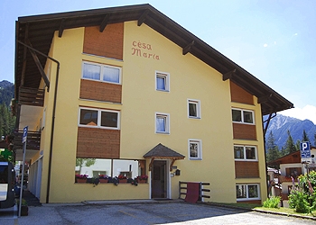 Apartment in Canazei. Welcome to the apartments Cesa Maria	

In the center of Canazei, “Cesa Maria” offers a wide range of comfortable apartments which combine the  typical mountain style furnishings into the warmest welcome.
Walking few steps from Cesa Maria you can reach easily all shops and services of primary importance.
Cesa Maria apartments are about 600 metres from the cable car station in Canazei far away and 2 minutes walking distance from the stop bus, from where you can catch the free ski bus to reach the ski lifts of Canazei, Campitello, or Alba. 
In just two minutes, you'll get to the town park and to the start point of numerous trails for walking.
We offer a large car park with private parking ( two-room apartment: 1 assigned parking space, three-room apartment: 2  assigned parking spaces ) 
A free ski and bike storage room is at your disposal
Prams and strollers may be left in the entrance
7 newly-refurbished apartments, consisting of 1 or 2 bedrooms, living room with kitchenette and 2 sofa beds, balcony (except in the attics), digital terrestrial TV, safe, bathroom with shower, microwave, dishwasher. 
We provide bed linen and on request baby cot for kids up to 2 years old.
