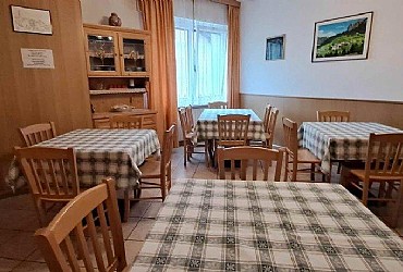Appartamento a Moena. Al pianterreno, la sala da pranzo, comoda e ampia per 20 persone e a fianco il salotto con TV-sat