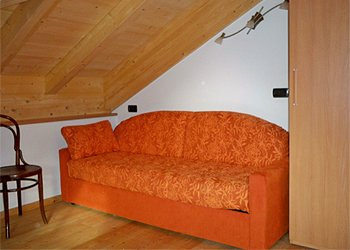 Apartment in Moena. Bedroom located in the mansard with sofa bed (two places).