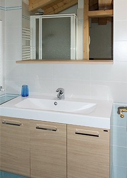 Apartment in Moena. One of the bathrooms located in the mansard.
