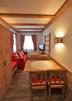 Apartment in Canazei. The apartment is furnished in typical mountain style.