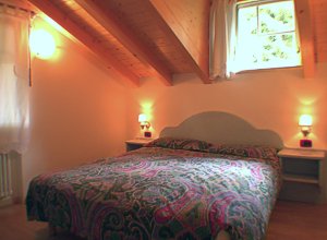 Residences in Campitello di Fassa. Bedroom of the apartment nr. 4 on the second floor.